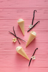 Tasty vanilla ice cream on color wooden background