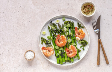Healthy appetizer. Seasonal salad from shrimp prawns and green asparagus.