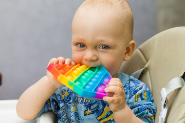 baby playing with colorful toy pop it