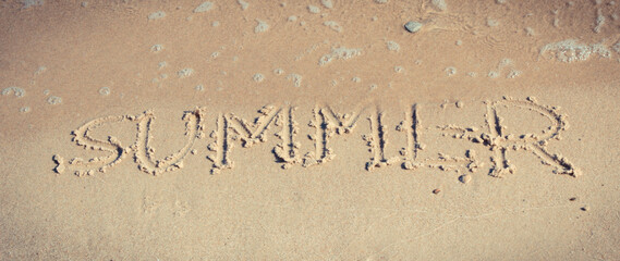 Inscription summer on sand at beach. Vacation time
