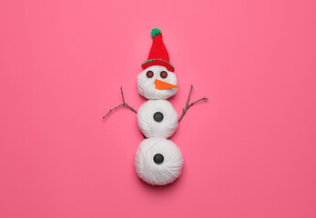 Funny snowman made of threads on color background