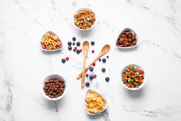 Creative composition with different cereals on light background