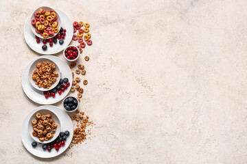 Composition with different cereals and berries on light background