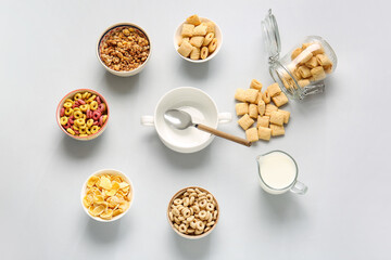 Composition with different cereals and milk on light background