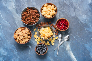 Composition with different cereals and berries on color background