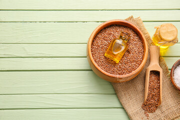 Composition with flax seeds and oil on color wooden background