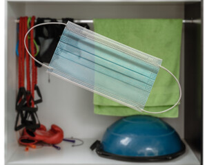 being indoors only in a sanitary mask, Closeup of shelf with sport inventory in modern fitness center