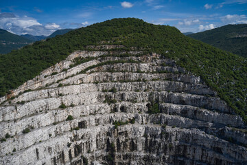 Top view of used mining in the alps. Panorama of developed mountain fossils. Italian marble...