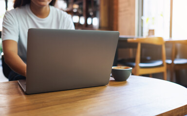 Closeup image of a woman using and working on laptop computer