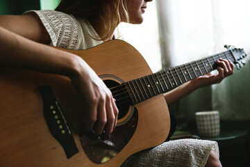 Girl playing an acoustic guitar - obrazy, fototapety, plakaty