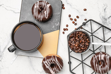 Composition with cup of coffee and donuts on marble background