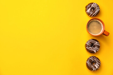 Composition with cup of coffee and donuts on color background