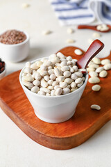 Bowl with beans on light background