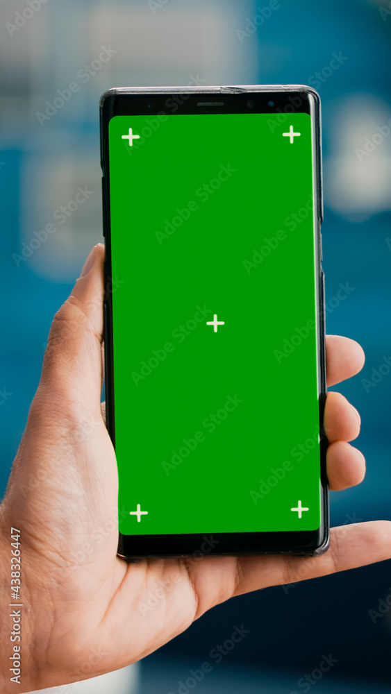 Poster pov of business man hands holding professional smartphone in portrait vertical mode with mock up gre