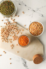 Different legumes on light background