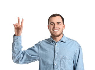 Naklejka premium Handsome man showing victory gesture on white background