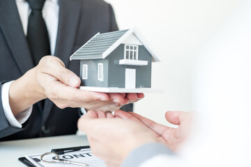 The real estate agent gives the house to a new owner's client after completing the signing of the lease and formally completing home insurance. Rental and insurance concepts