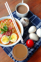 Photo of noodle soup with toppings such as sausages, eggs, and vegetables