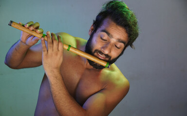 young man Playing flute passionately without cloths studio shot