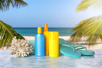 Beach accessories with sunscreen cream on table at tropical resort