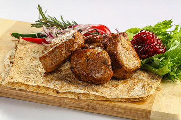 Pork tenderlion kebab over board