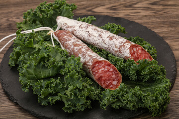 Spanish Fuet sausage with salad leaves