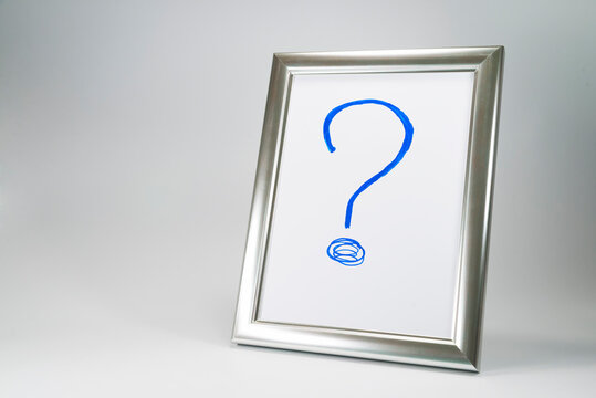 Hand drawn big blue question mark  in silver frame for the photo. Problem and solution concept in searching for a person. Free space.