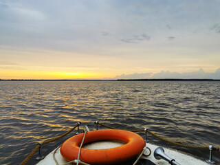 old motor boat at sunset went out on the water with a beautiful landscape