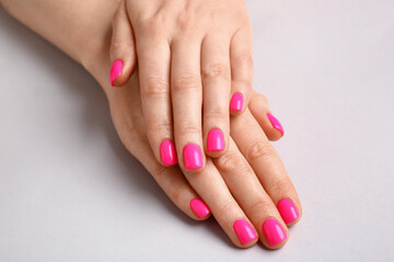 Woman with beautiful manicure on light background