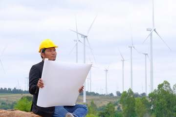 Engineers look at blueprints for clean energy wind turbine projects to generate electricity.