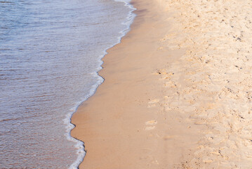 Soft wave of the sea on the sandy beach.Soft focus,blurred image.