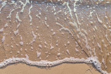 Soft wave of the sea on the sandy beach.Soft focus,blurred image.