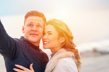 Happy romantic Smiling couple taking selfie on the sunny beach