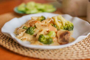 Roasted chicken mushroom pepper pasta in a white plate. toning. selective focus