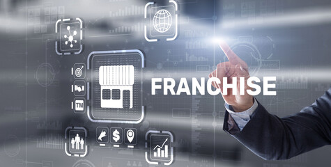 Businessman hand touching inscription Franchise marketing system
