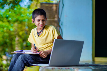 Asian boy using Laptop computer for online study homeschooling during home quarantine. homeschooling, online study, home quarantine, online learning, corona virus or education technology concept