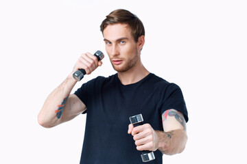 Fototapeta na wymiar man with dumbbells in his hands Sport Fitness tattoo on his arm and white background