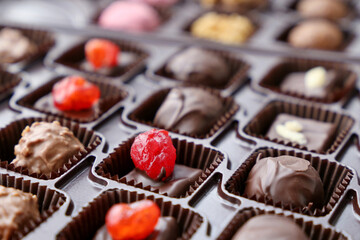 Chocolate candy in a gift box. Assorted sweets with nuts and berries