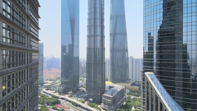 Drone aerial view of modern skyscraper and Shanghai downtown skyline. Epic closeup view of Lujiazui building. Business economy travel concept b-roll footage office building exterior with modern design
