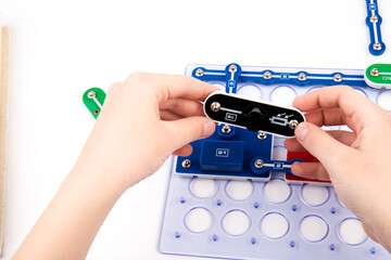 Child and electronic constructor isolated on white background