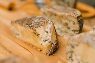 Pieces of blue cheese by hand on the counter sample