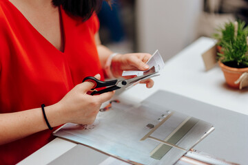 Fototapeta premium Designer cutting a pattern in a paper