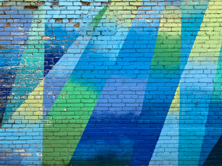 brick wall painted with colorful bright geometric abstract pattern