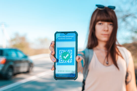 Portrait of a woman holding a smartphone with a negative test results for coronavirus. Digital health passport. The concept of a new normal and travel during the pandemic