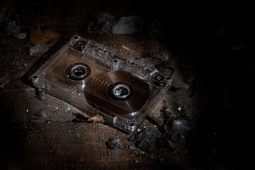 Old vintage cassette tapes on a pile of dirt and dust