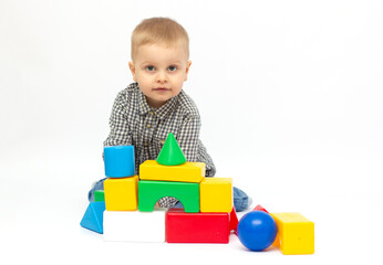 toddler child boy playing toy blocks isolated on white