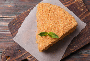 piece of honey cake with a sprig of mint on the board, dessert