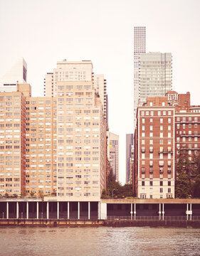 Residential buildings along East River waterfront, retro color toned picture, New York City, USA.