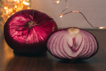 Red sweet onion and Christmas lights. Half an onion. Ingredient for making salad