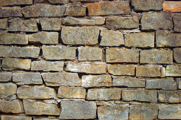 Aged stone wall texture background. antique rock masonry